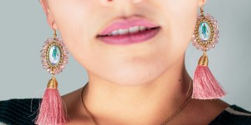 woman wearing silver necklace and earrings