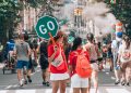 woman in red top holding Go sign