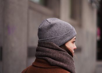 person in gray knit cap and brown hoodie