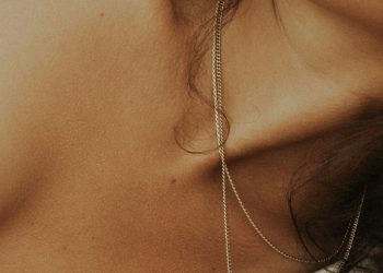 woman in white tank top wearing silver necklace