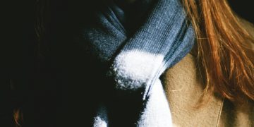 woman wearing brown top and black scarf