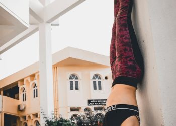 person in black and white nike running shoes and red pants
