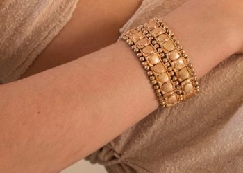 a person wearing a gold bracelet