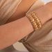 a person wearing a gold bracelet