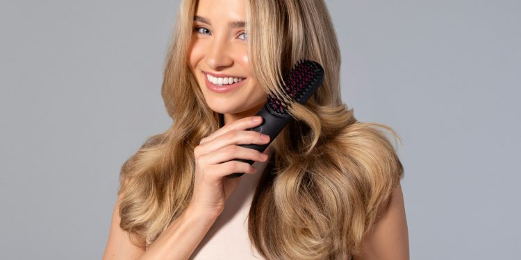 a woman holding a hair brush in her hand