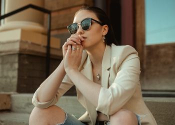 a woman sitting on the steps of a building
