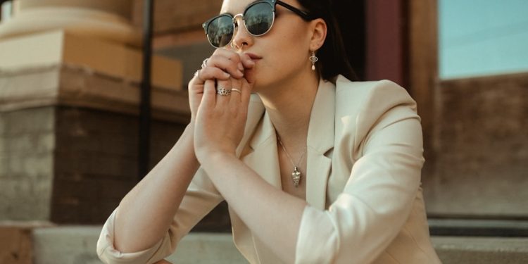 a woman sitting on the steps of a building