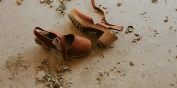 pair of brown ankle-strap sandals on floor