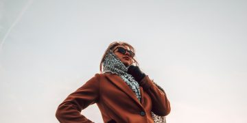 woman wearing brown peaked-lapel topcoat