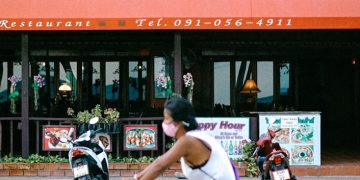 man in white shirt riding on bicycle during daytime