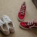 a pair of red and white tennis shoes on the floor